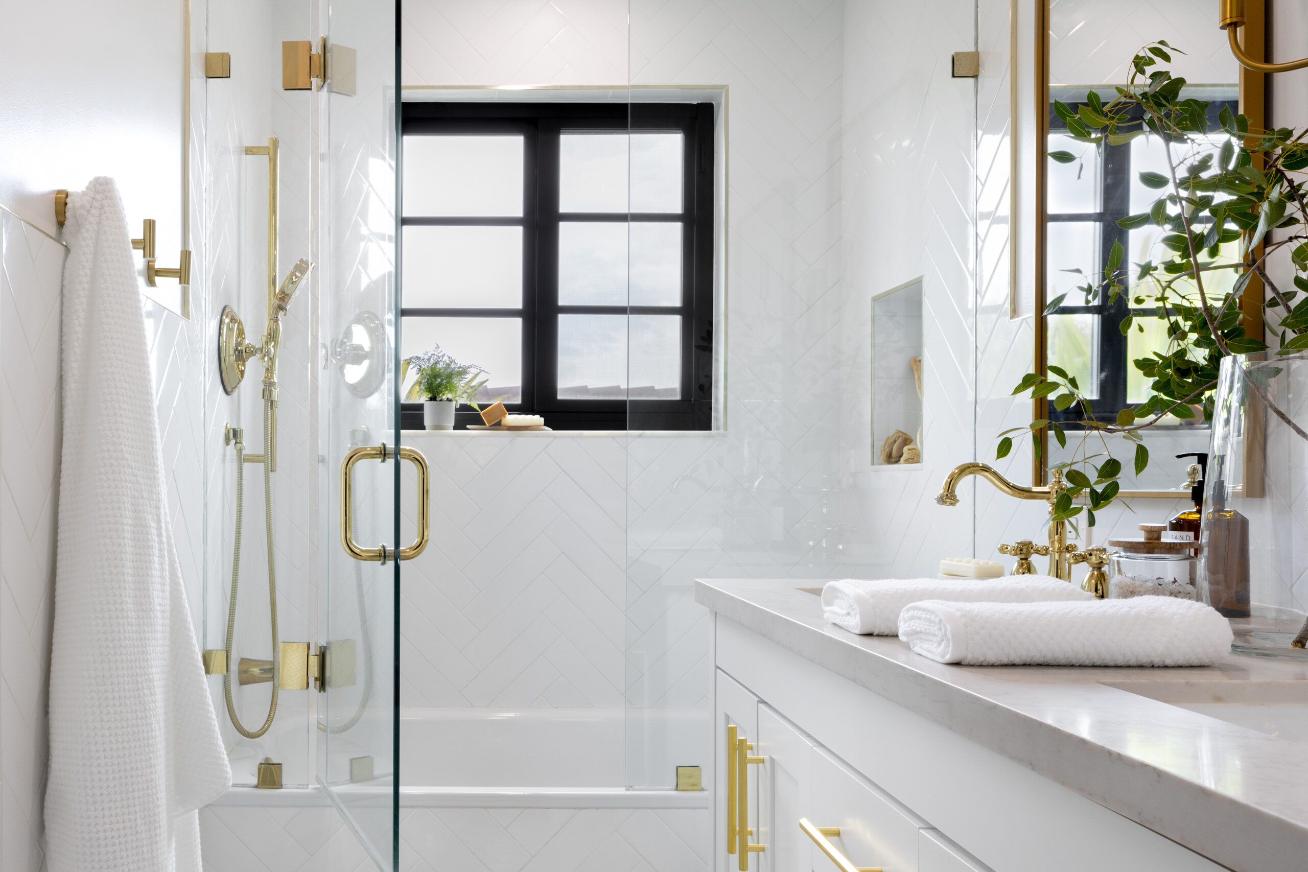 Bathroom renovated by Kathryn Fulton, White with gold accents.