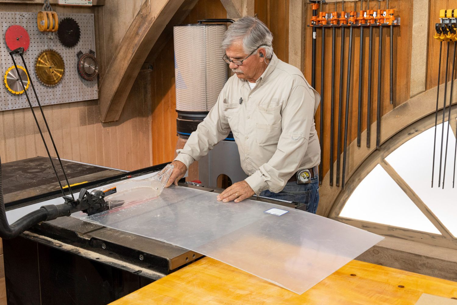 Tom Silva using a table saw to cut plexiglass into smaller strips