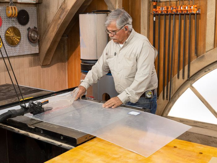 Tom Silva using a table saw to cut plexiglass into smaller strips