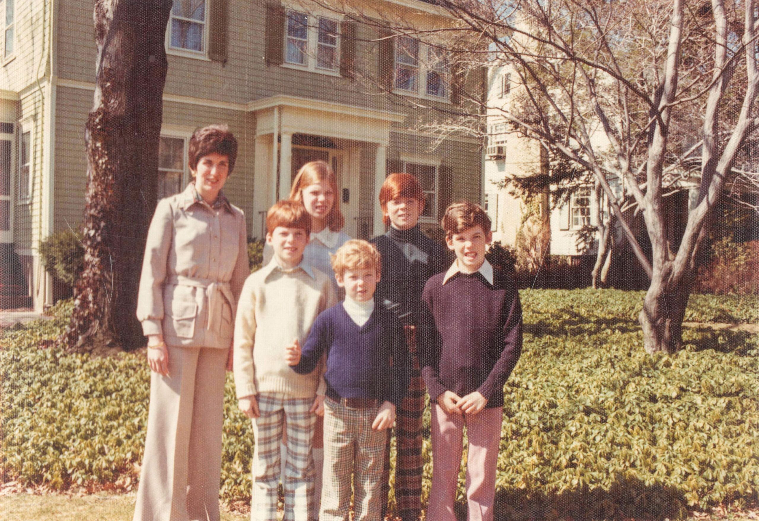 Kevin O'Connor with his mom and siblings in front of the family's house.