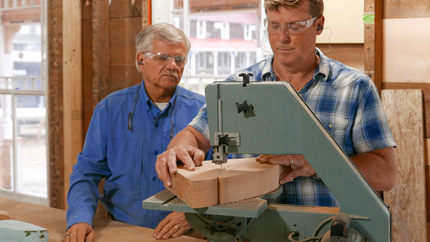 Kevin O'connor and Tom Silva using a band saw to create a cornice