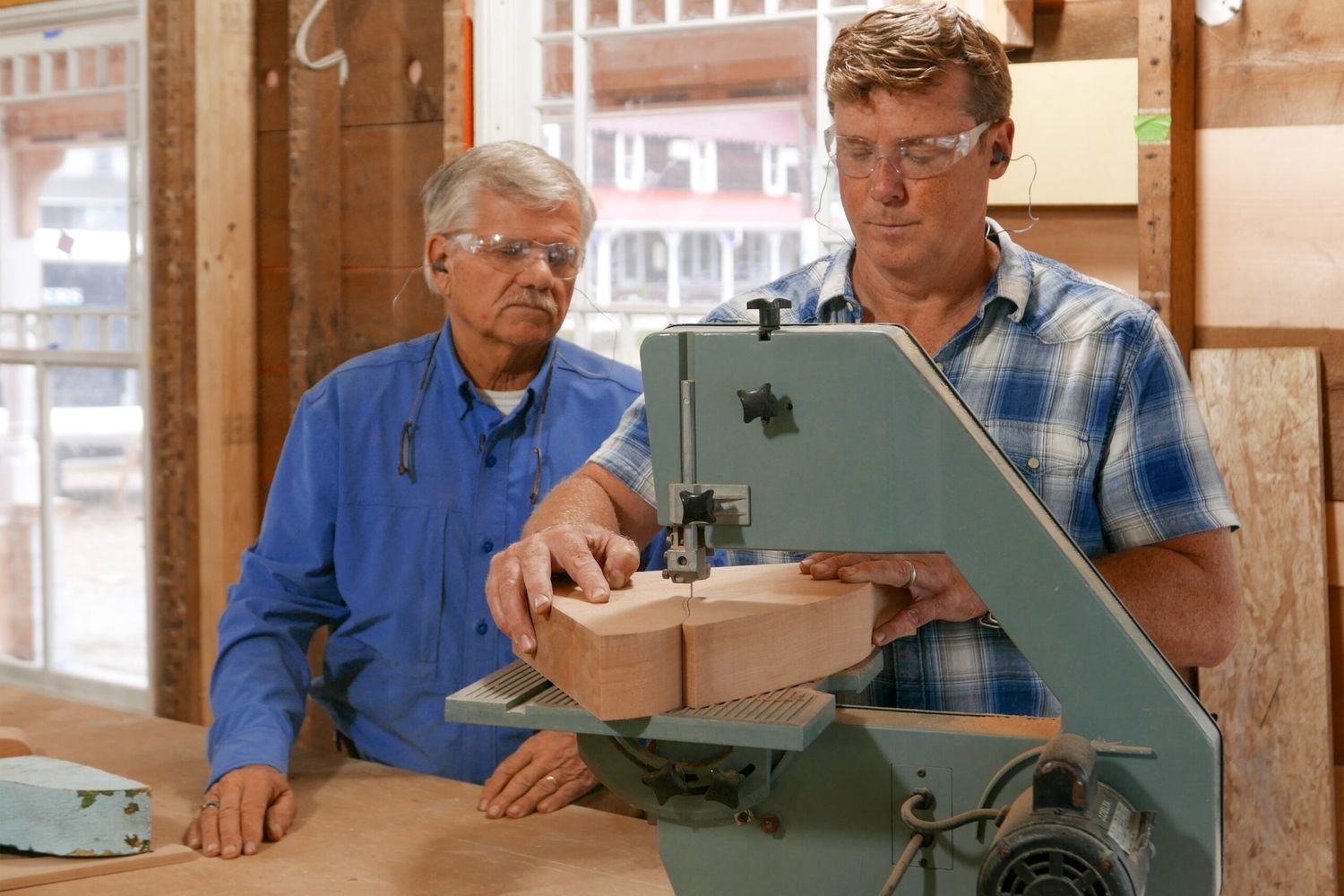 Kevin O'connor and Tom Silva using a band saw to create a cornice