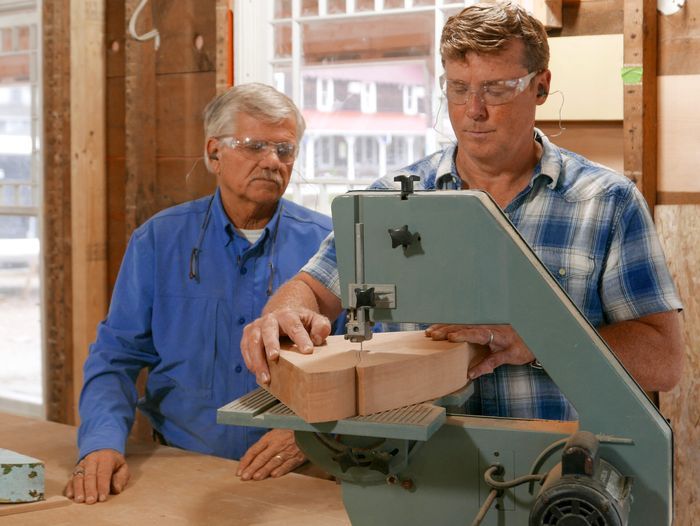 Kevin O'connor and Tom Silva using a band saw to create a cornice