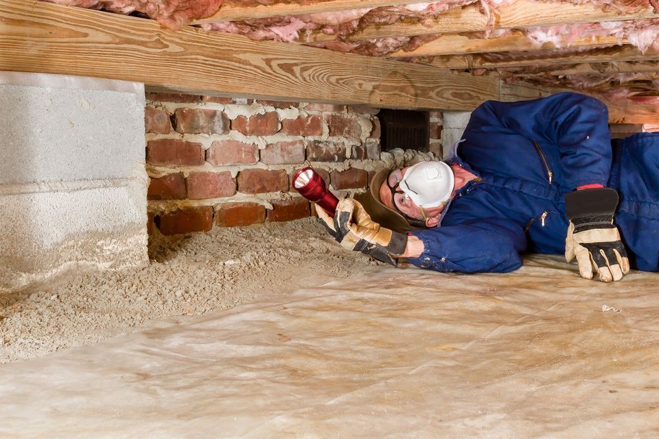 Man checking crawl space in home